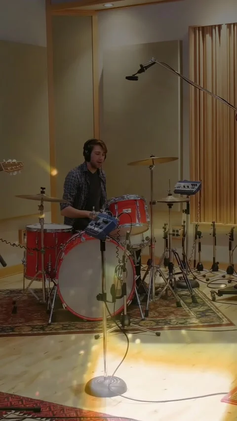 Vertical video: Drummer tapping kit, checking pad, locking rhythm in studio as Stock Footage 334391088