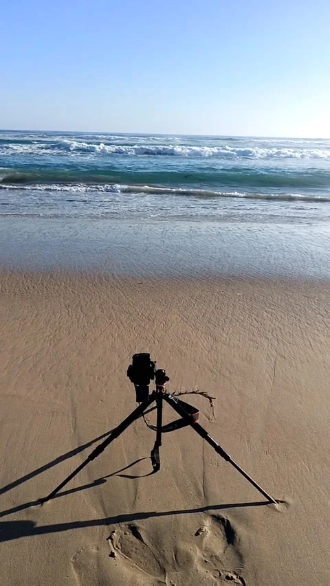 Vertical video of dslr camera on the beach shore Stock Footage 233382885