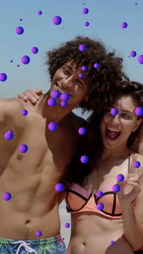 Vertical video: Duo posing beach social, woman flashing peace sign causing Stock Footage 333896159