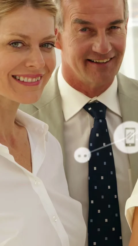 Vertical video: Duo posing as pullback revealing faces, phone icons drifting Video stock 334599138