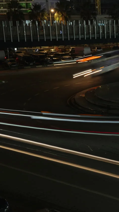 Vertical video dynamic night traffic light trails on roundabout. Timelapse of Stock Footage 335852689