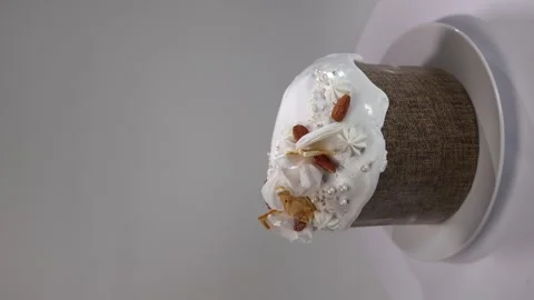 Vertical video. Easter cake on a white background covered with icing, almonds Video stock 274233288