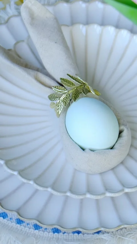 Vertical video. Easter table setting with decorated Easter egg 動画素材 332701490