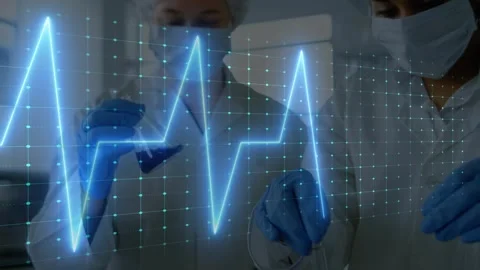 Vertical video: ECG overlay sweeping, two techs using pipette on tubes at lab Stock Footage 330540449