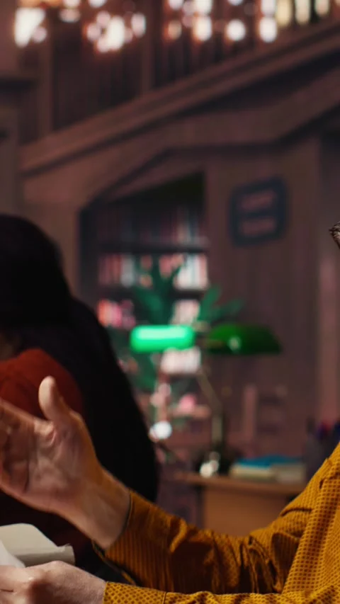 Vertical Video Elderly actor in a library focusing on script reading and Stock Footage 313245760