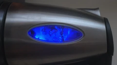 Vertical video of electric kettle with boiling water in neon blue lighting Video stock 245086319