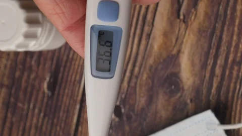 Vertical video. Electronic Thermometer Shows A Temperature Of 36.6 Degrees Celsi Stock-Footage 128630659