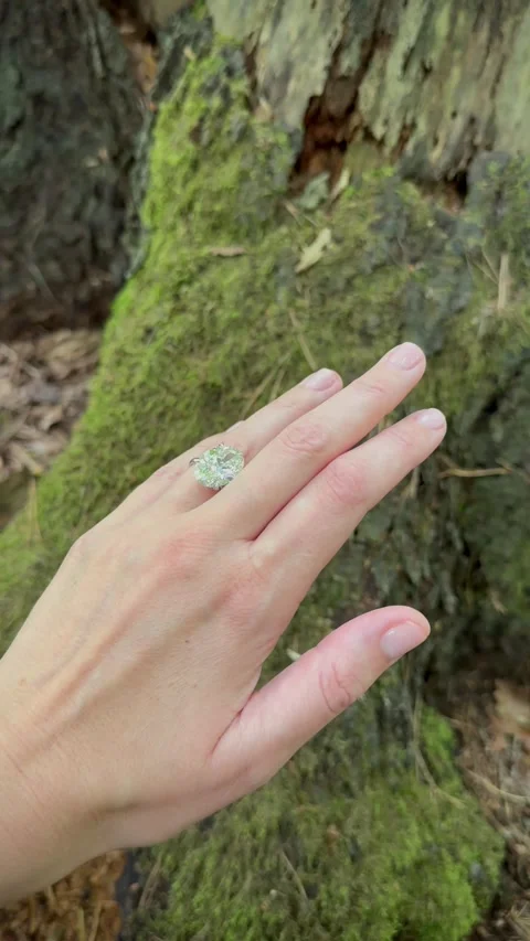 Vertical video of elegant hand with oval diamond engagement ring outside 스톡 동영상 317335581