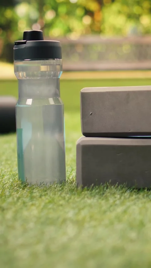 Vertical Video Empty city park with yoga brick and foam roller placed on mat on Stock Footage 346615929