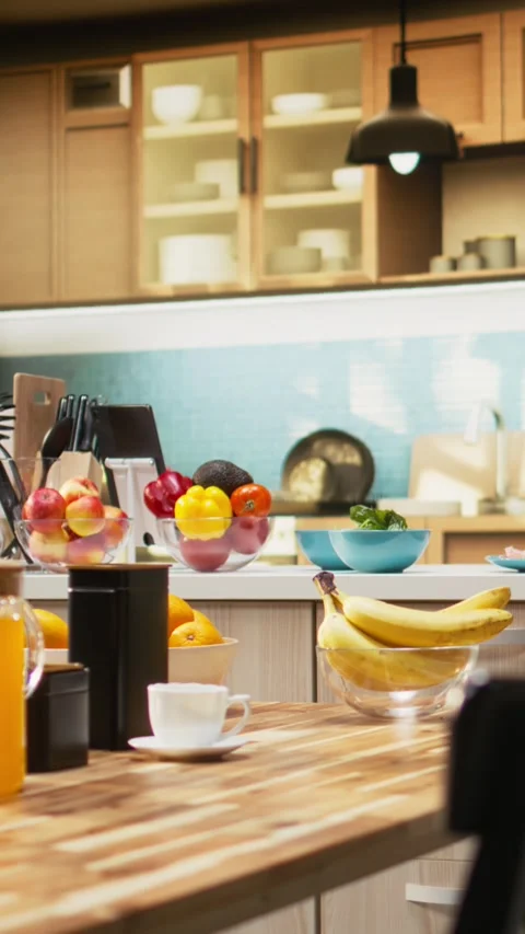 Vertical Video Empty kitchen with wooden dining furniture and modern appliances Stock Footage 325681149