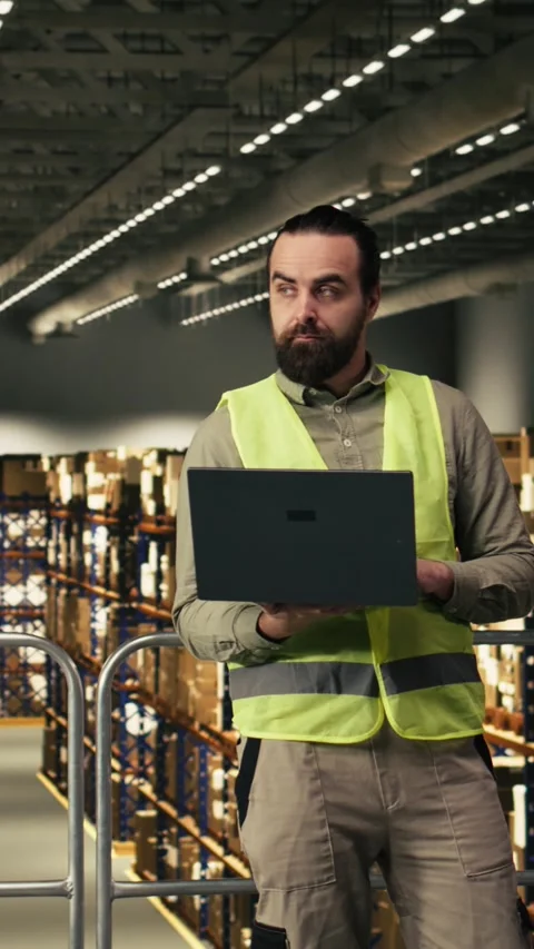 Vertical Video Empty logistics warehouse with computer monitor running tracking Stock Footage 330203986
