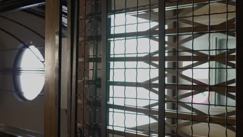 Vertical video of empty old elevator descending and passing by at the Stockbeeldmateriaal 254018286