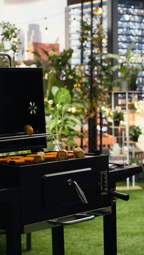 Vertical Video Empty rooftop barbecue setup with grilled food and bottled drinks Stock Footage 347187166