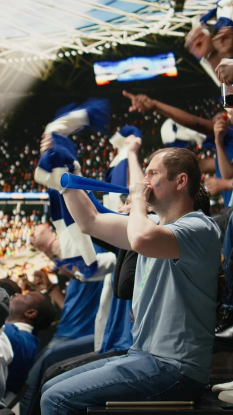 Vertical Video Energetic supporters beating percussion drum and blowing Stock Footage 335690127
