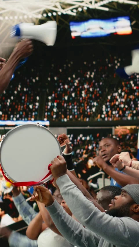 Vertical Video Energetic supporters beating percussion drum and blowing Stock Footage 335690736
