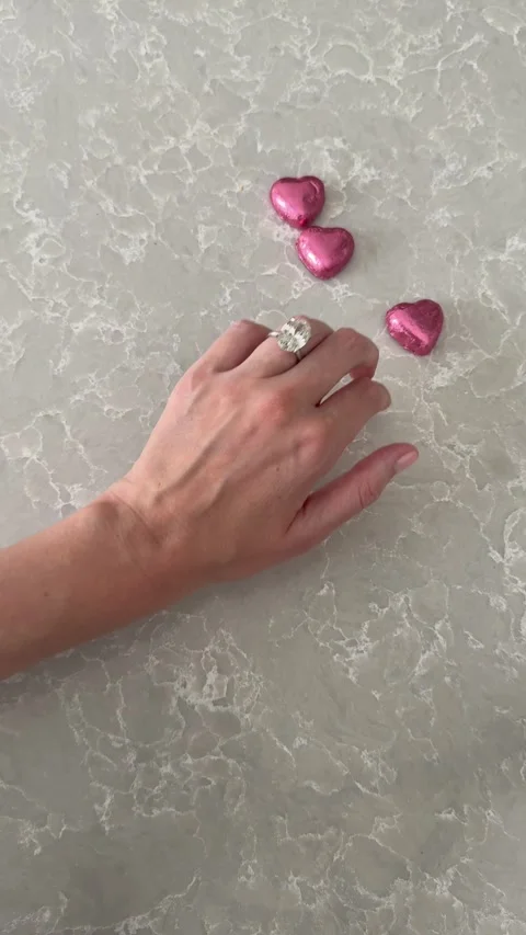 Vertical video of engagement ring or wedding band with hearts for Valentines Day Stock Footage 316749948