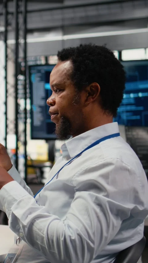 Vertical video Engineer chatting with manager in office, laughing while using AI Stock Footage 322696329