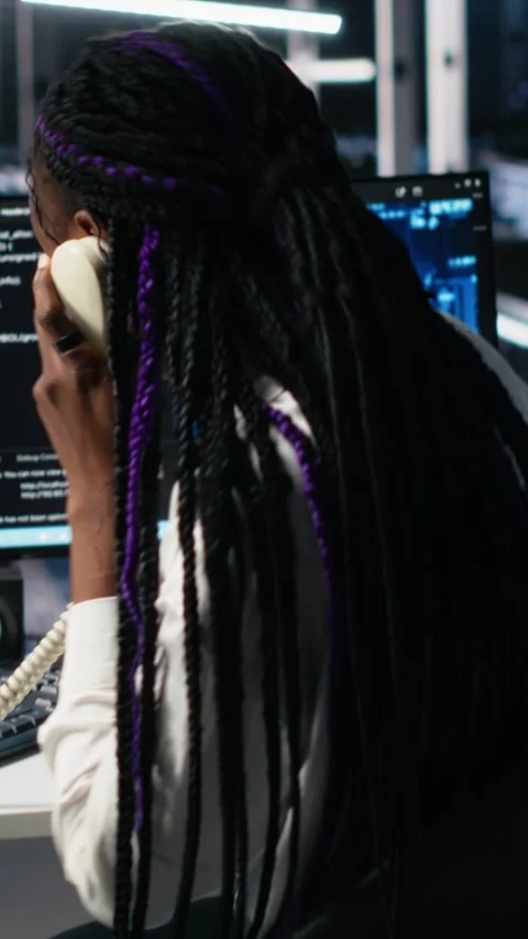 Vertical video Engineer in data center answers telephone call, assisting users Stock Footage 313455597