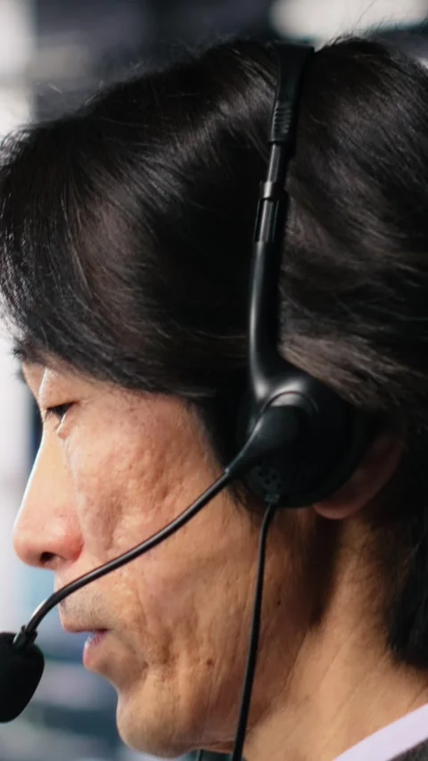 Vertical video Engineer in data center wearing headset assisting users with AI Stock Footage 313455763