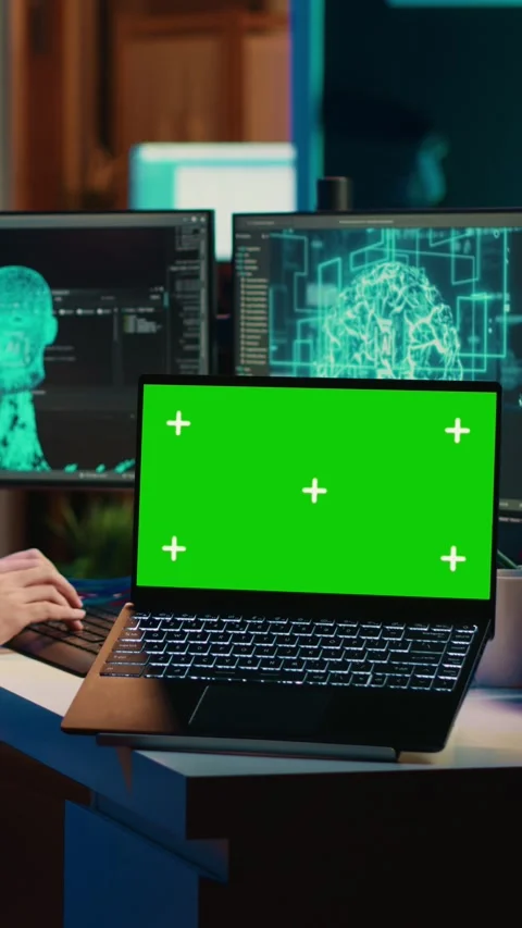 Vertical video Engineer with EEG headset on merging with AI, green screen laptop Stock Footage 266747718