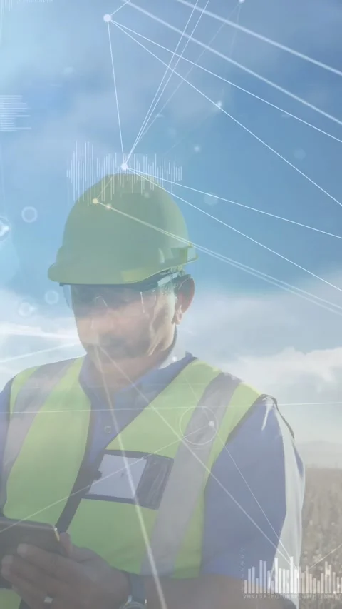 Vertical video: Engineer entering frame raising tablet, HUD overlaying him while Stock Footage 332846146
