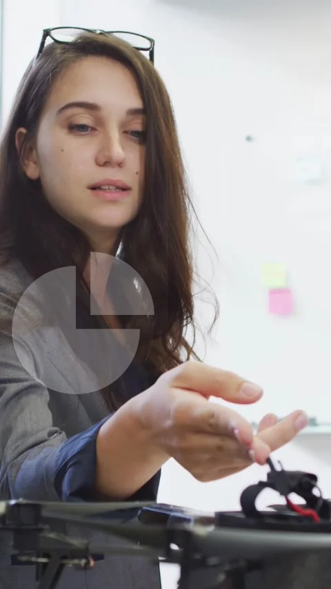 Vertical video: Engineer explaining drone on table reaching, inspecting props Stock Footage 333157506