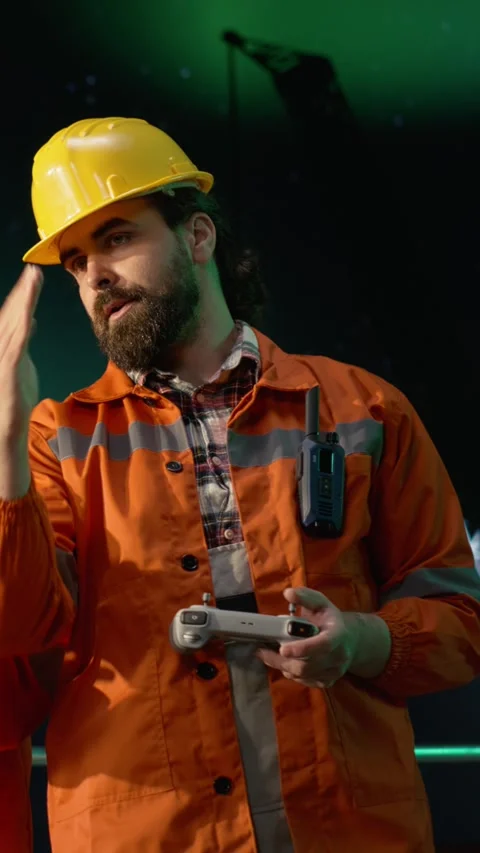 Vertical video Engineer on offshore rig under aurora borealis uses drone to Stock Footage 339889259