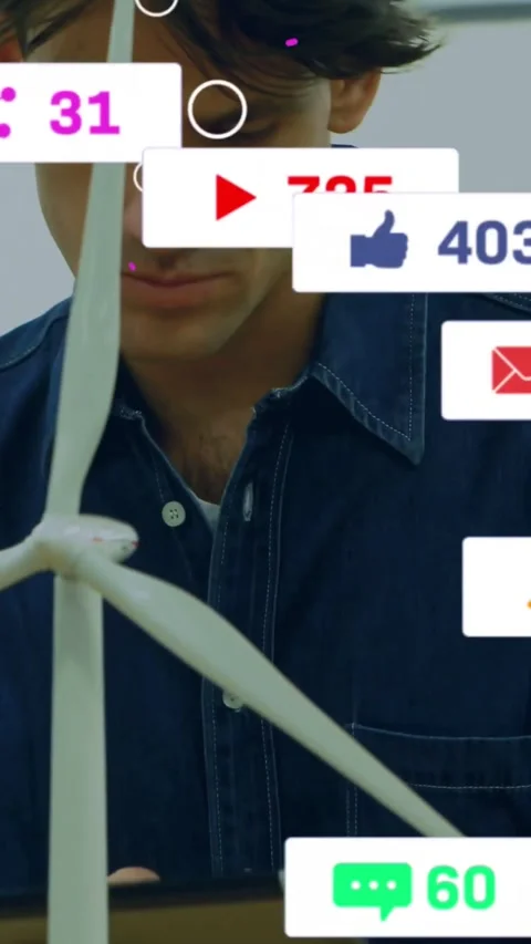 Vertical video: Engineer tapping tablet beside turbine model, monitoring social Stock Footage 334386814