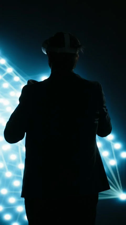 Vertical video Engineer wearing VR headset gear to look at glowing AI neural Stock Footage 329451561