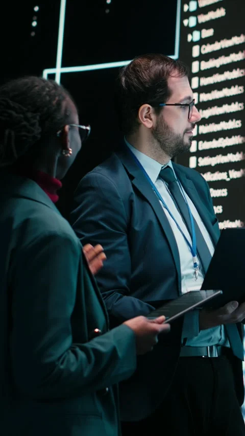 Vertical video Engineering team looks at AI machine learning self writing code Stock Footage 329649801