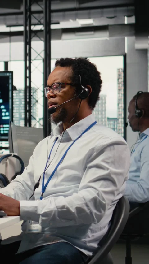 Vertical video Engineering team in office providing remote diagnostics Stock Footage 323331071