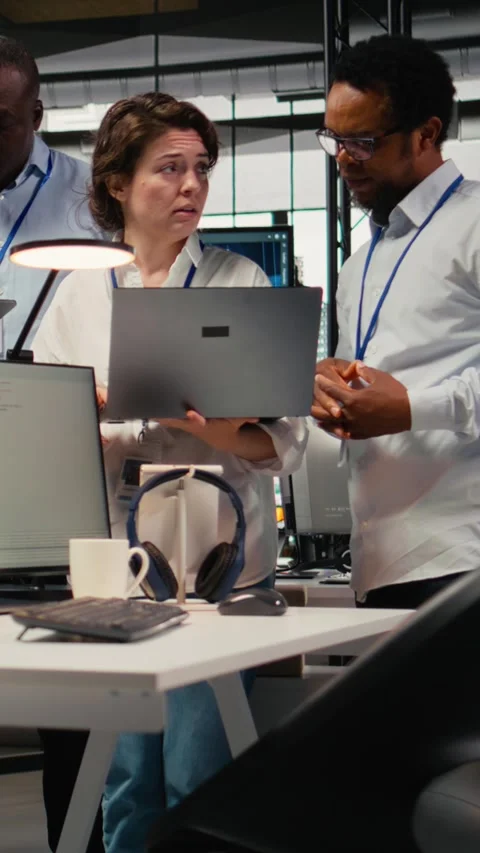 Vertical video Engineering team working together in office, using AI specialized Stock Footage 322696233