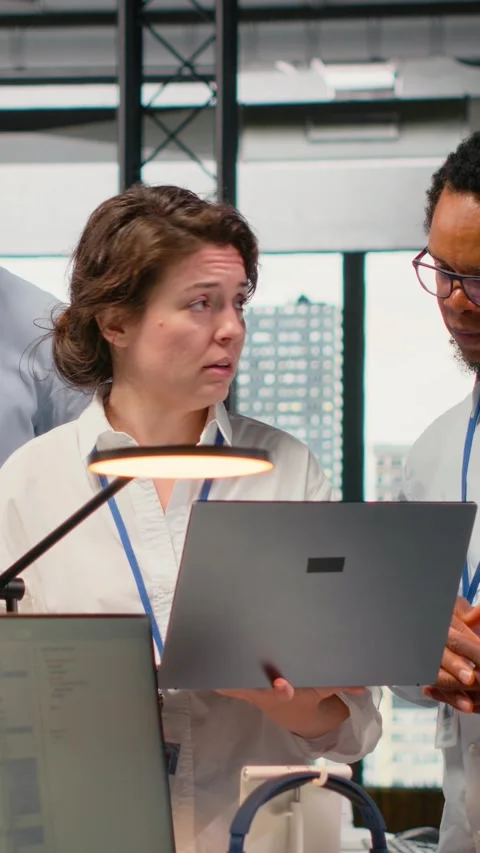 Vertical video Engineering team working together in office, using AI specialized Video stock 323330175