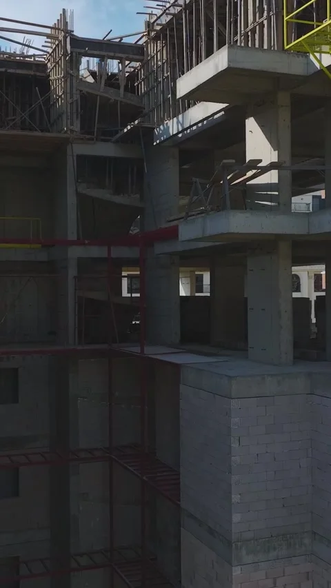 Vertical Video: Engineers and Workers Collaborating on Metalwork, Concrete, and Stock Footage 342910285