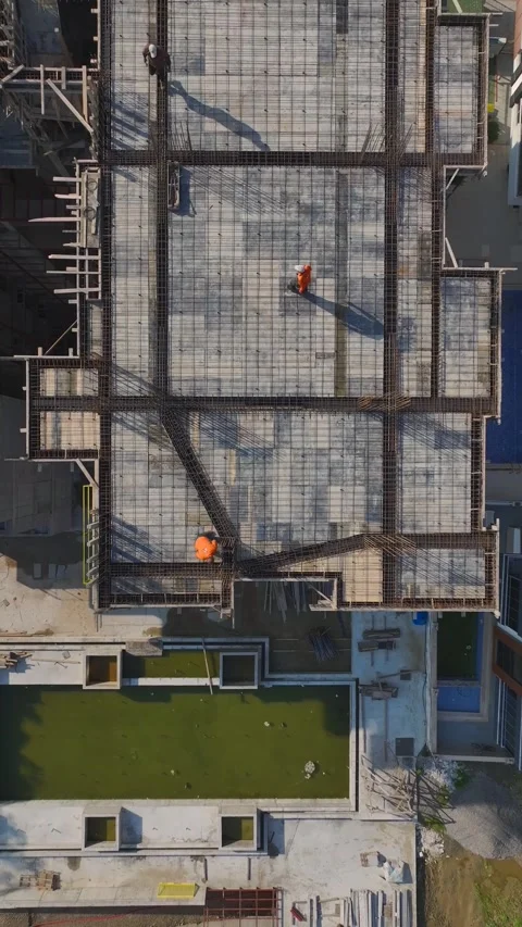 Vertical Video: Engineers Collaborating With Workers Building Walls and Using Stock Footage 342601543