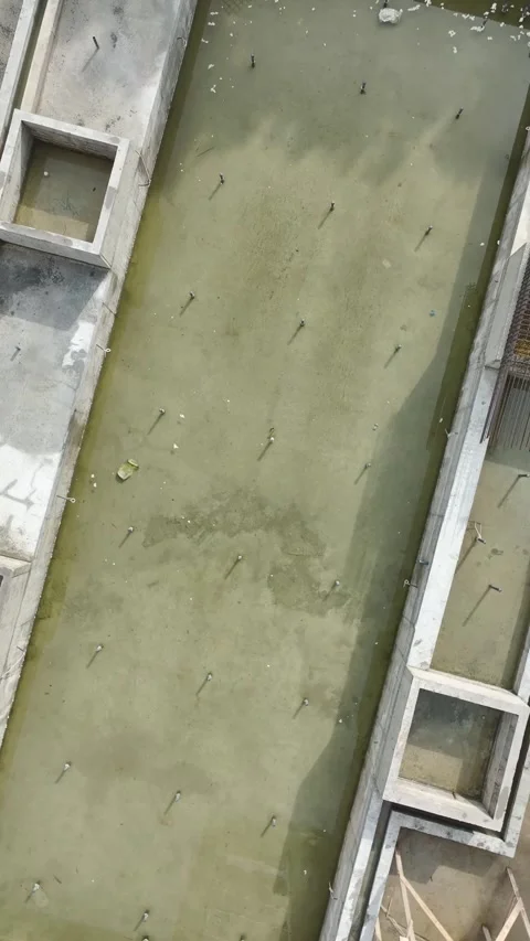 Vertical Video: Engineers guide workers at a busy construction site preparing Stock Footage 297639227