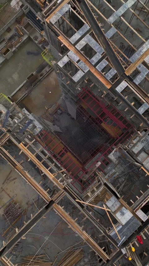 Vertical Video of Engineers Inspecting Wall Alignment on Multi-Story Project Stock Footage 342406441