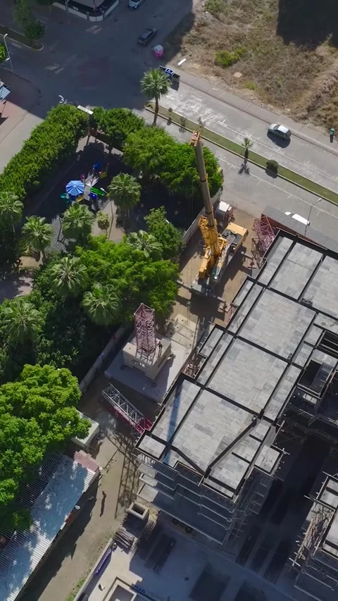 Vertical Video: Engineers Joining Crane Parts On A Construction Site Captured Stock Footage 297695779