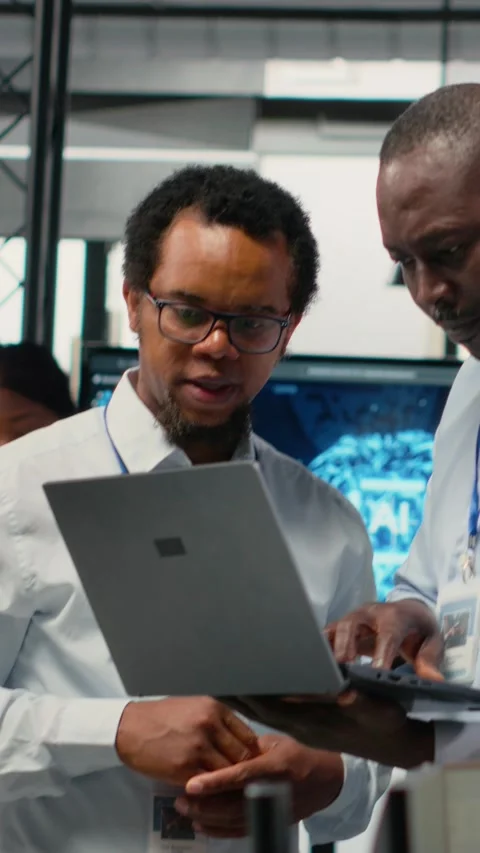 Vertical video Engineers in office doing software development to launch new Stock Footage 323141968