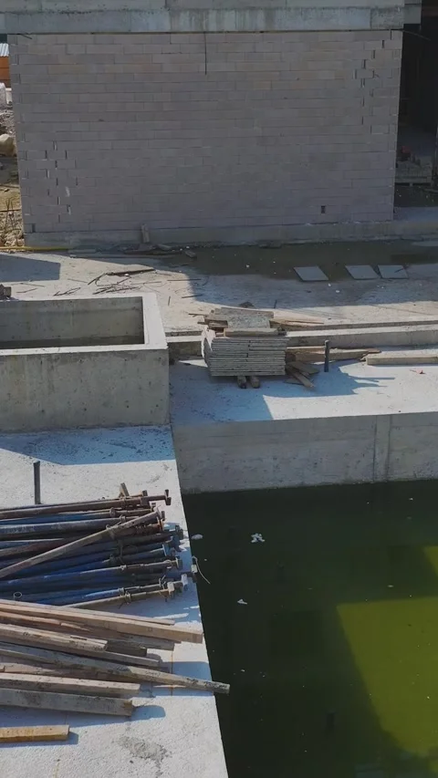 Vertical Video: Engineers Plan While Workers Use Metal and Concrete to Build Stock Footage 342912136