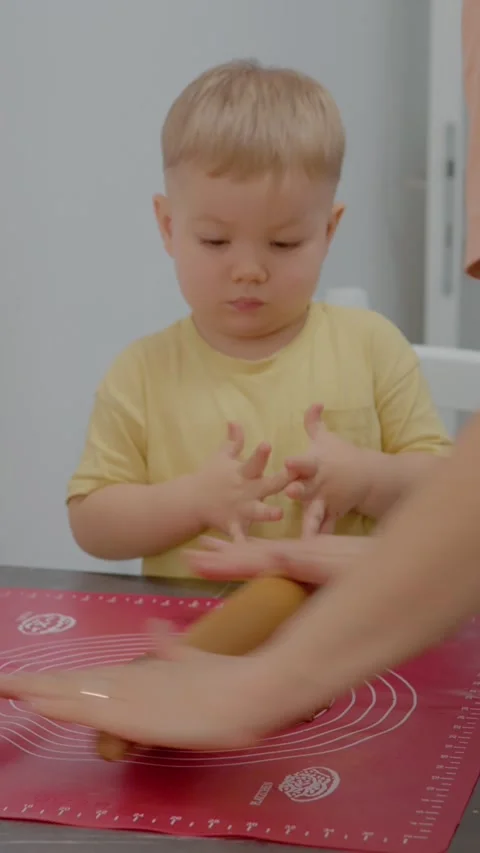 Vertical video Enjoying cookie making time with child in a cozy kitchen Stock Footage 329628923