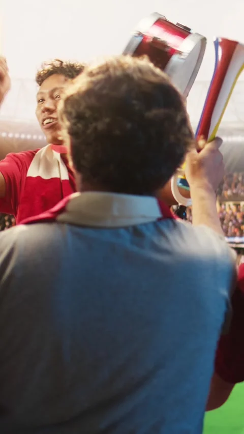 Vertical video Enthusiastic man on soccer stadium beating drum, encourage team Stock Footage 341679149