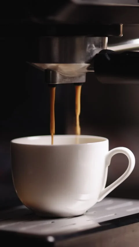 Vertical Video of Espresso machine making fresh coffee. Pouring coffee stream Stock Footage 305233260