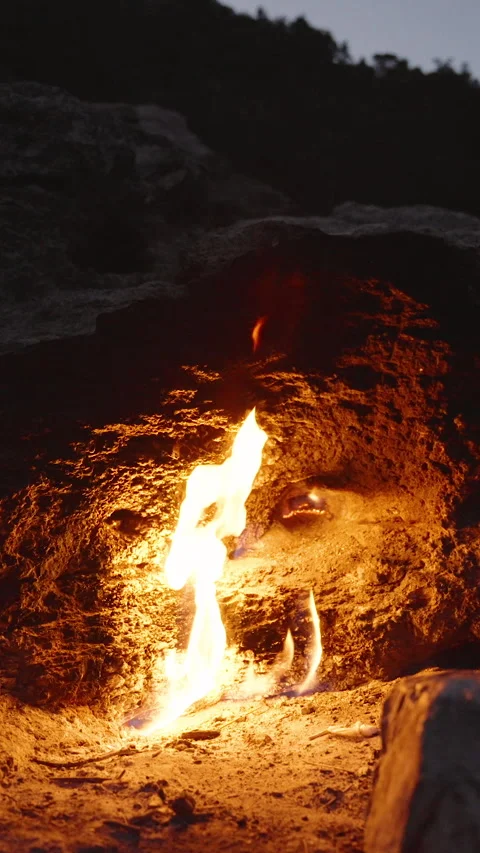 Vertical video. Eternal Flames Emerging from a Rocky Surface at the Chimaera in Stock Footage 304175844