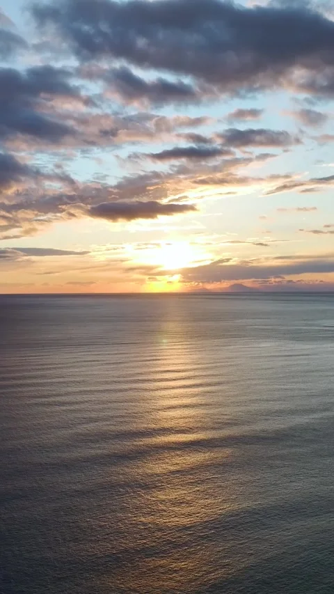 Vertical Video of Evening Waves Under Warm Sun Stock Footage 342318601