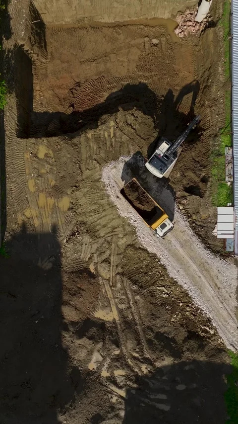 Vertical Video Excavator Loading Soil into Truck Near Road Top View Stock-Footage 342441410