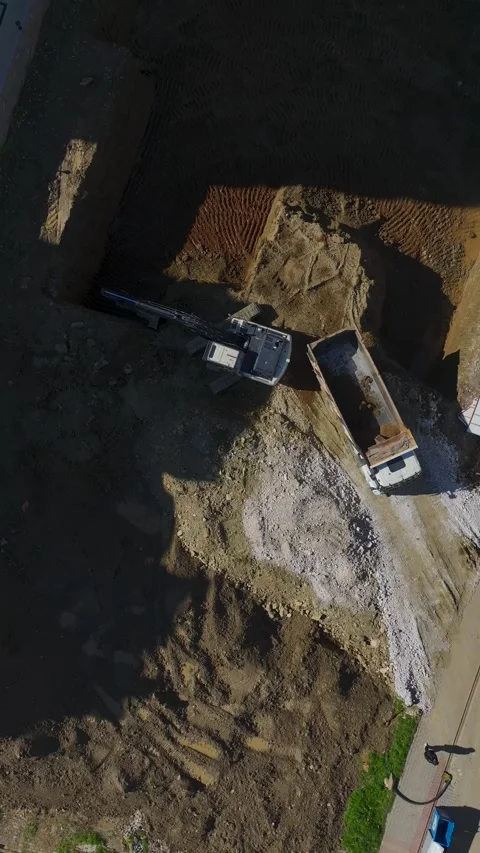 Vertical Video Excavator Working in Deep Hole at Construction Site Stock Footage 342469563