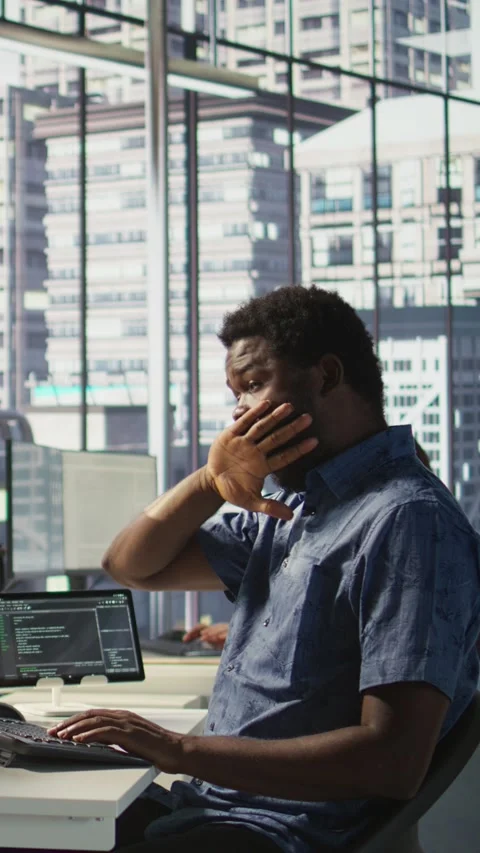 Vertical video Exhausted man being sleepy in workspace, programming on computer Stock Footage 319491755