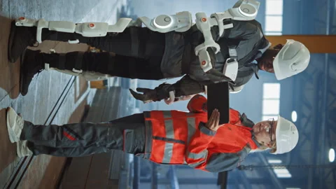 Vertical Video Exoskeleton Factory Worker Stock Footage 142636989