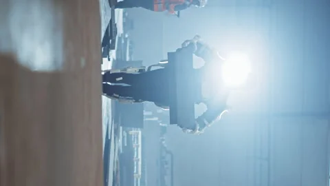 Vertical Video Exoskeleton Factory Worker lifting Construction Stock Footage 142637110